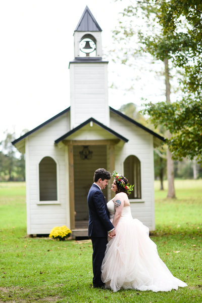 Couple in front of tiny chapel, The Hideaway in Brookhaven, MS, MIssissippi Wedding