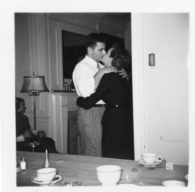 Vintage photo of couple at house party kissing