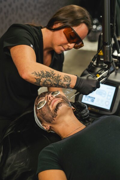 Client receiving luxury skin treatment from a licensed technician in a private Pittsburgh laser lounge.