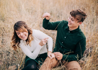 Engaged couple laughing and teasing each other during their engagement session