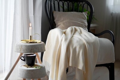 Photo of sitting chair with white blanket draped over it, a comforting scene.