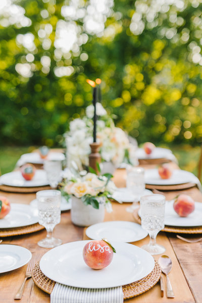 table setting with white plates & peaches