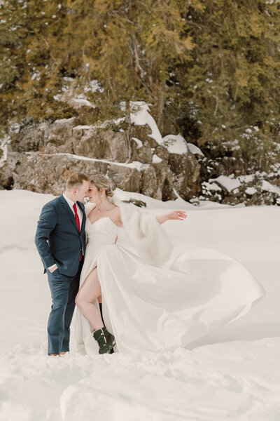 Bride and groom wearing snow boots