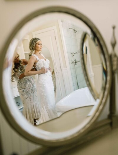 Bride Getting into Dress Mirror Reflection - Mikayla & Mario | Harmony Meadows Wedding - Lake Chelan Wedding