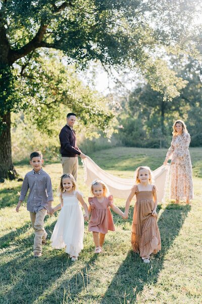 Mother and father walking to beach holding baby