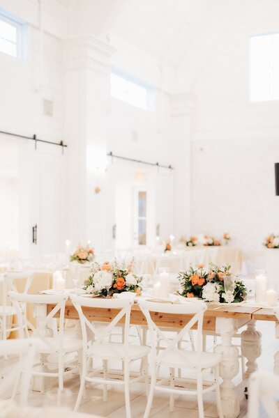 Elegant wedding reception with orange flowers and natural wood elements