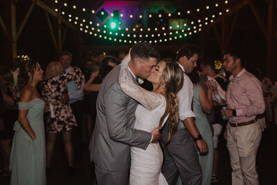 Kansas City Wedding Photographer, wedding at Schwinn Barn Farm, bride and groom kissing at reception