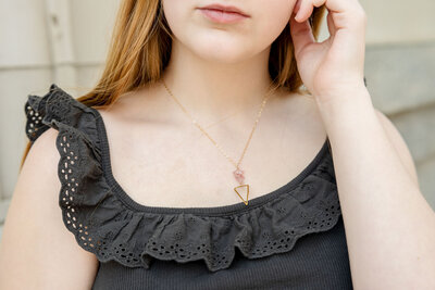close up image of young woman wearing a handmade necklace