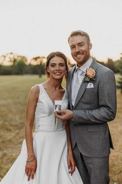 bride and groom smiling at camera