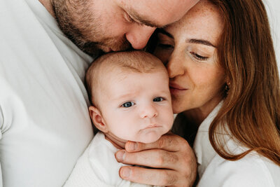 Young baby looking at camera on a natural baby photoshoot