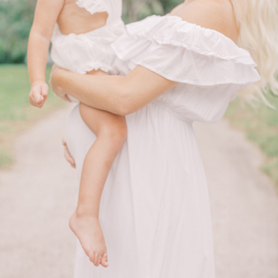 newborn baby girl wearing white bow
