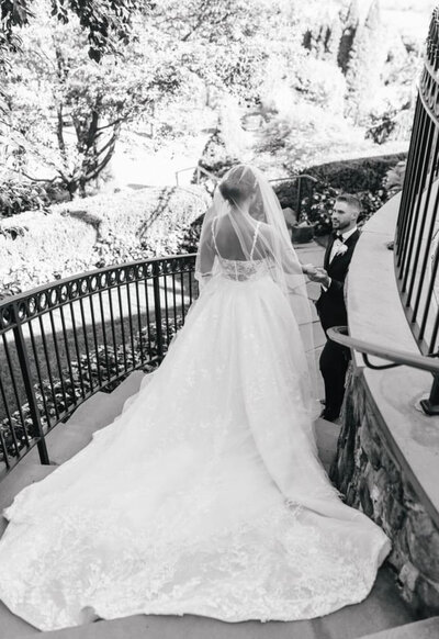 bride meets groom at stairs