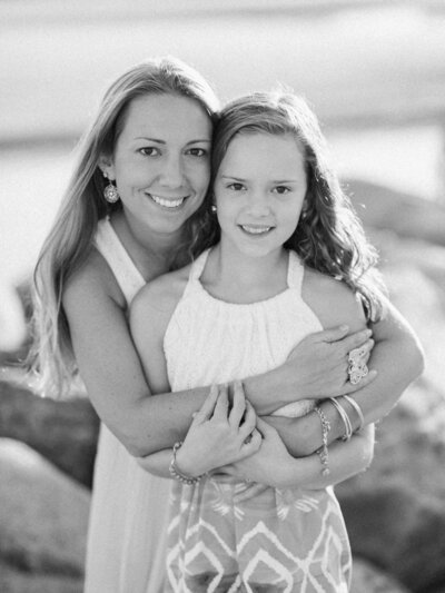 classic black and white portrait of a mother and daughter during a family session on ocean park beach in saco maine by carrie pellerin
