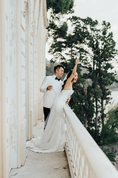 bride and groom yelling off balcony
