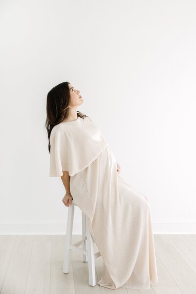 Mom in field in tulle dress outside charlotte maternity