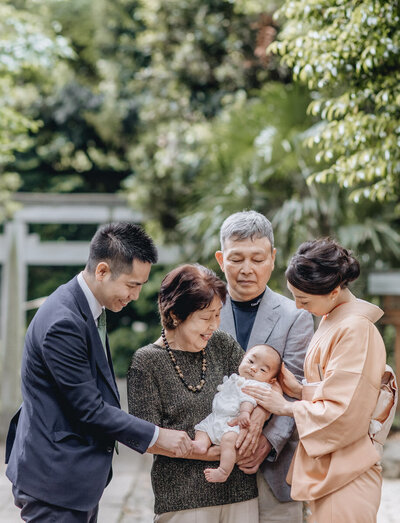 Grandparents holding a newborn baby at Omiyamairi Photosession