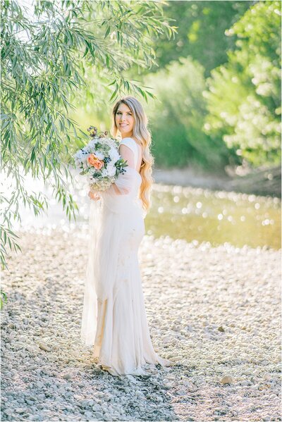 Sacramento Wedding Photographer captures bride holding bridal bouquet during outdoor portraits