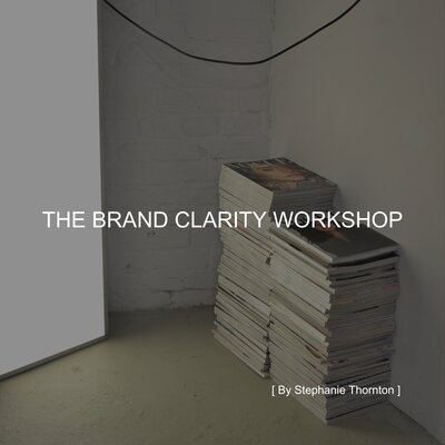 THE BRAND CLARITY WORKSHOP  text on top of photo of magazines stacked beside a lightbox.