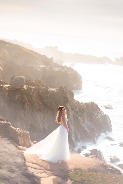 A beautiful bride standing on the edge of a cliff