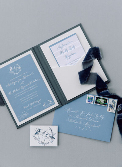Pocket folder linen folio blue invitation suite with handwritten calligraphy scripts and envelope calligraphy