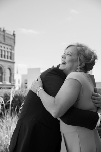 Mother & son hugging on wedding day