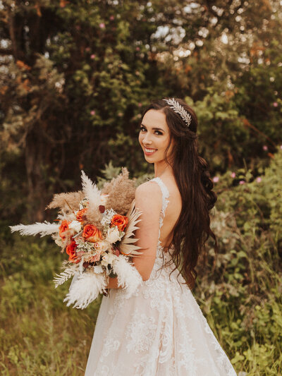 bride posing with bouquet