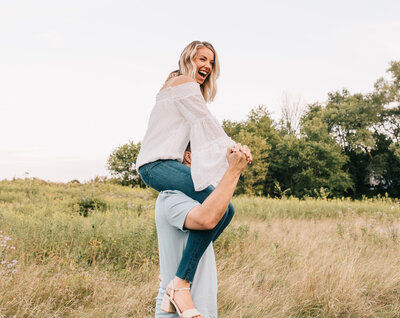 Woman on man's shoulders laughing