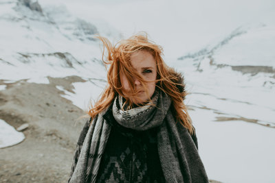 woman wearing scarf with mountains in background