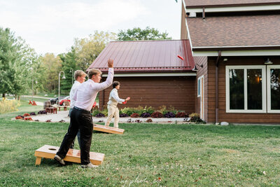 guests playing conhole at barnwood events in madiscon, winconsin.