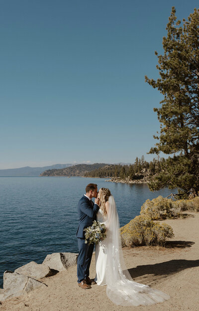 wedding couple kissing by the lake in tahoe