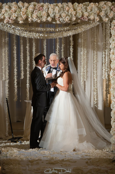 bride and groom under chuppah