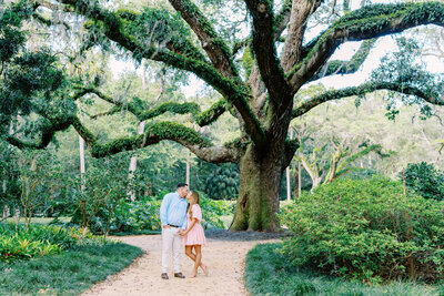 A couple walking along the path at Washington Oaks Gardens for their engagement session