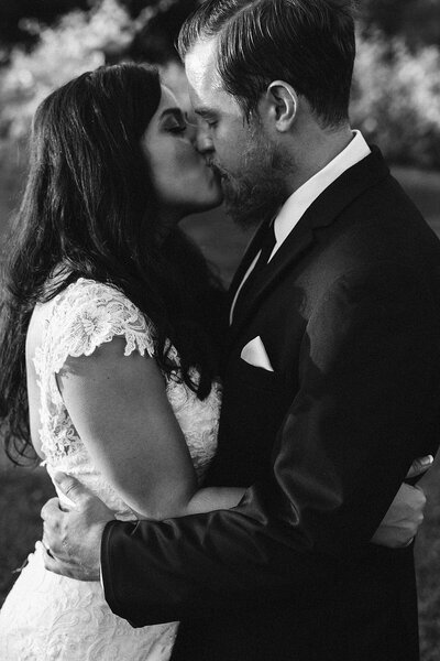Couple sharing a romantic kiss, photo is in black and white