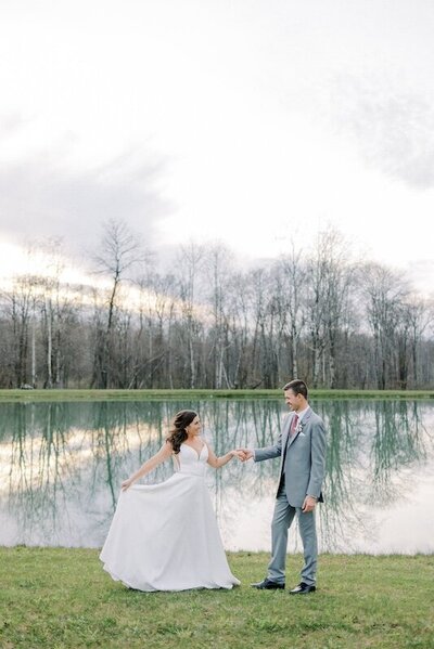 Couple holding hands in front of pond