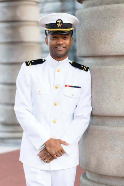 Naval Naval Academy Midshipman smiles for senior photos in Annapolis, Maryland.