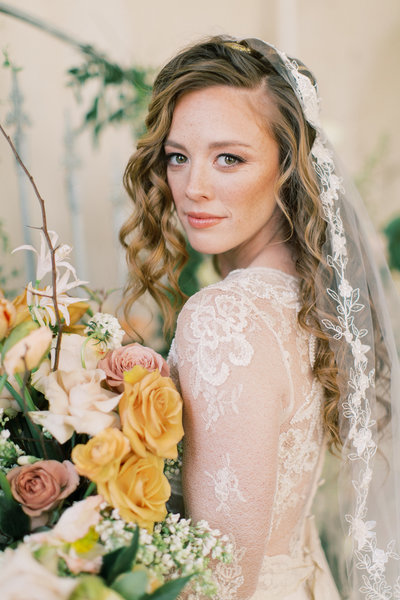 bride wearing lace gown with long veil and boho chic bridal bouquet at Lancaster PA wedding