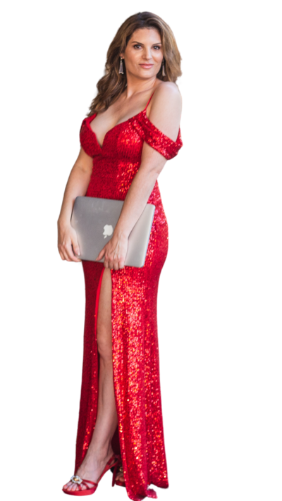 Melanie is wearing a long red sequined gown, red heels, and holding an Apple MacBook