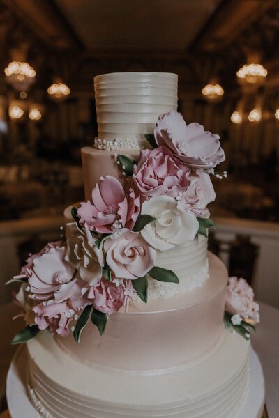 Wedding cake with flower decorations on it - UME (New England Wedding Planners) were a wedding vendor