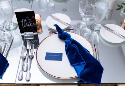 Table setting at wedding with white plate and blue napkin, Destination Wedding at The Palms Hotel in Miami, FL