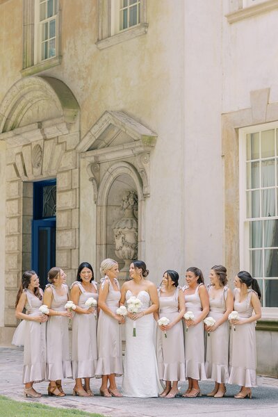 Bride and bridal party stands outside venue in Atlanta at the Swan House