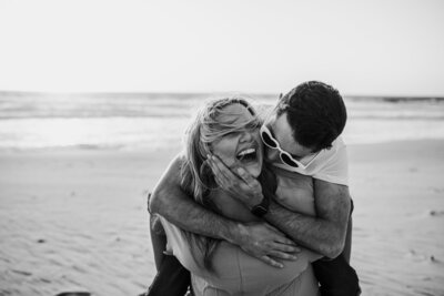 couple laughing on the beach