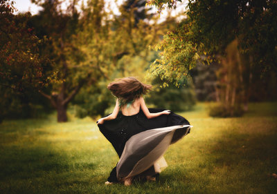Girl twirling portrait in black gown