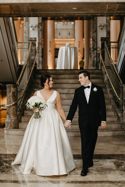 bride and groom with white rose bouquet at nashville symphony