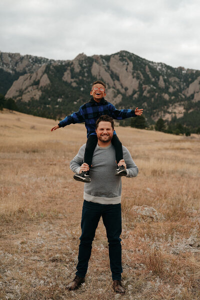 little boy on dad's shoulders