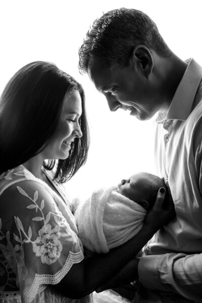 New parents looking at newborn baby, taken by nj newborn photographer
