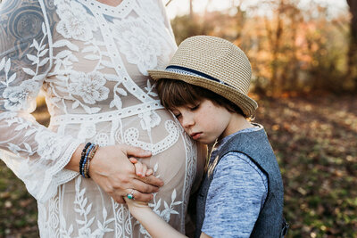 boy hugging mom pregnant belly-01