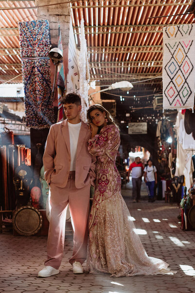 bride and groom pose in marrakesh street market