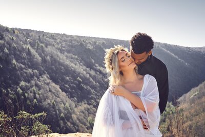Couple stands near cliff in West Virginia