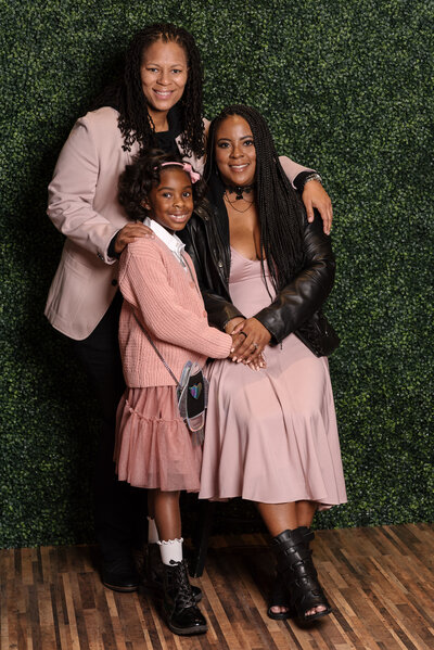 Lesbian married couple in formal attire with daughter