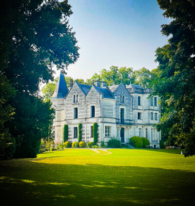 Elegant 19th-century French chateau surrounded by gardens and rolling countryside, home to intimate creative and painting retreats blending art, culture, and wellness.